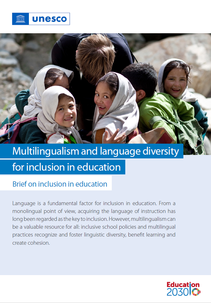 School children showing their faces and smiling,  and adult bending his head in the middle of the children